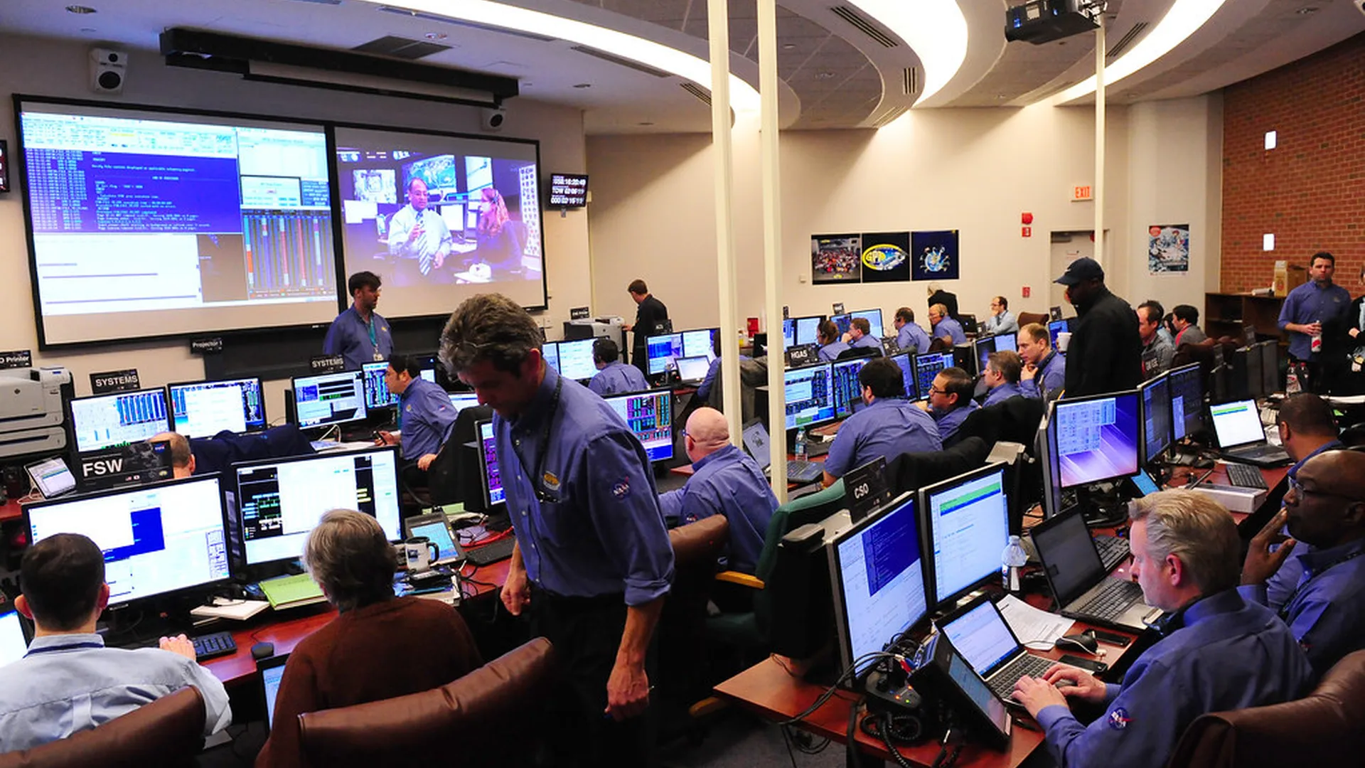 Market close figures shown on a monitor next to a cup of coffee